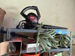 Shelf and all includes many rugs, electric leaf blower, yard flags, lawn edging, yaktrax
