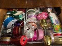 Contents of dresser include holiday decor, wrapping paper, tissue paper, ribbon and bags