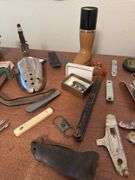 Assorted smalls includes merscham style pipe, ice cleats, pocket knives, old razor, bullets, gal on leg nut cracker, ash tray set w/matching holder and more