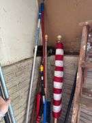 In corner includes US flag, trap, chair cushions, window scrapers , yard tools, 5’ wooden painters ladder