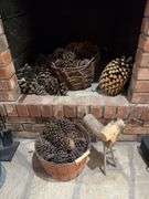 Baskets of pine cones and a wooden reindeer