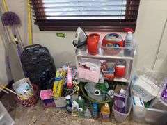 Cleaning supplies, luggage, hangers, paper items, small shelf, laundry soap and more