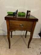 Sewing machine cabinet and notions
