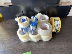 Quantity of Staples brand packing tape, dispensers, boxes, 500’ roll CAUTION tape