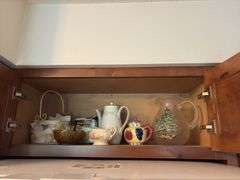 Tupperware, silverplate, cookbooks, glassware, coffee mugs, etc "A" cupboards
