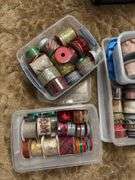 Several rolls of ribbons in totes