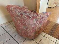 Orange and red toned Southwest style swivel padded armchair