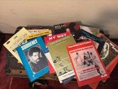 Sheet music and variety of music books, music stand