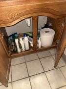 Contents of bathrooms includes (2) two  drawer cabinets, cleaning supplies, paper products, etc