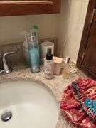Contents of two baths includes cleaning supplies, bandaids, scales, rugs, etc