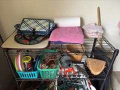 Wire shelf unit and contents includes drop cords, decor, cord wraps, cat litter, Preen, etc