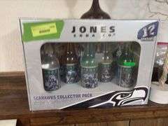 On ledge includes Jones Soda Co Seattle Seahawks collector pack, Easter tree, planters, hurricane shades, etc