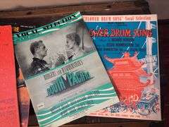 Sheet music and variety of music books, music stand