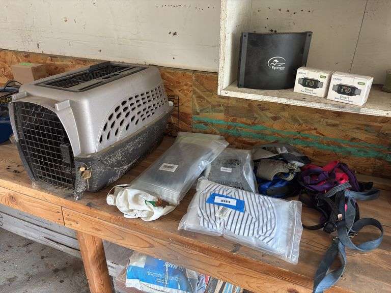 Miscellaneous dog and pet items include smart bark training collars, large assortment of new in package leak proof doggy diaper diapers, small kennel, leashes, and collars image