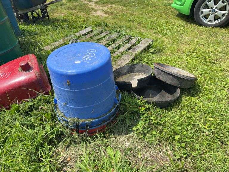 Three plastic feed buckets and hog pans image