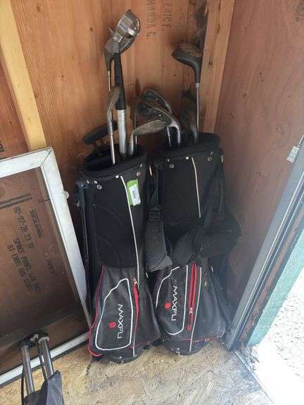 Two golf bags and two partial sets of clubs image