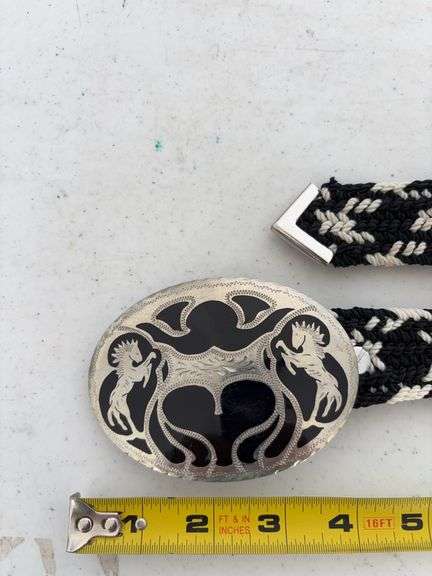 Belt buckle marked Hand Crafted Denver Colorado- has a unreadable word in front of Silver plus belt image