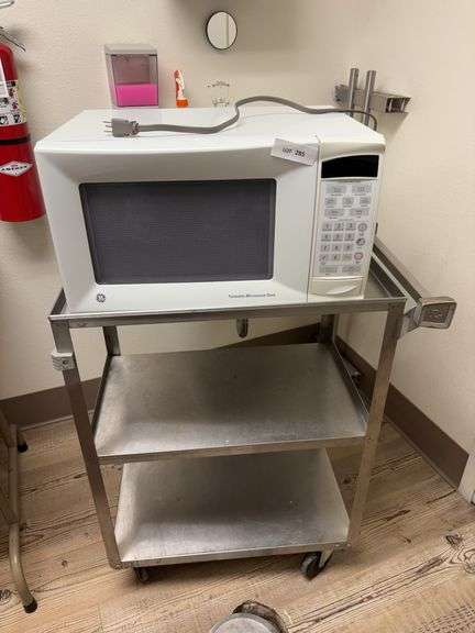 GE Microwave and stainless serving cart on rollers image