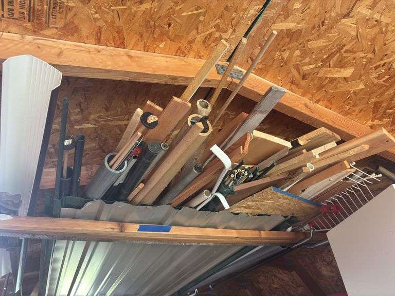 Building material - lumber, framing, trim, and closet material in rafters on both sheds image