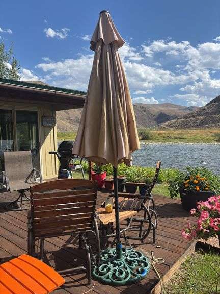 Large porch umbrella with very heavy umbrella stand and two fold up side tables image