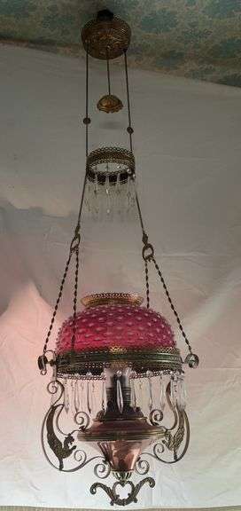Cranberry opalescent prism hanging lamp with copper and brass font, two matching rings x 2, smoke bell, cord reel, winged gargoyles on font sides image