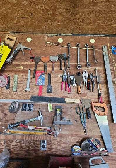 Saws, ruler, scrapers, vise grips, caulk gun, corn knife image