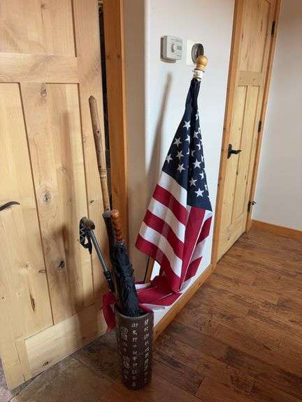 Umbrella stand, umbrellas, pole flag, walking sticks image