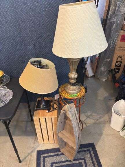 Two table lamps, canoe display shelf, and side table plant stand image