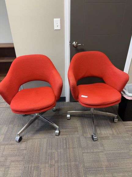 Two orange swivel chairs image