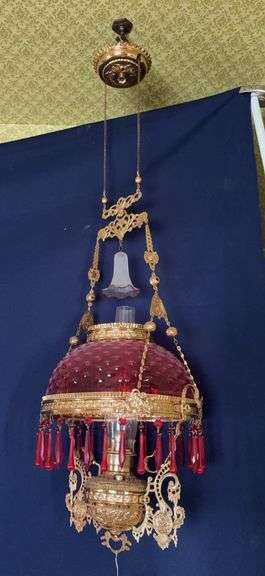 Hanging prism lamp w cranberry shade, smoke bell, two matching rings, retractable reel, professionally polished, brass font, red glass alternating shape prisms image