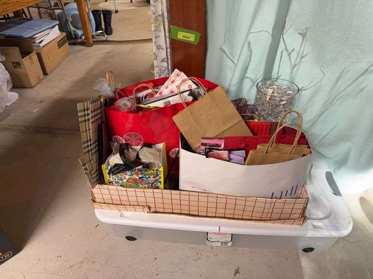 Many gift bags and a rolling under bed tote to hide them away in! image