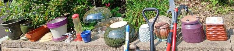 Assortment of planters on retaining wall image