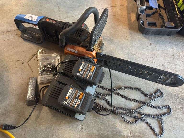 Worx brand battery powered chainsaw with two batteries and docking system and extra chains image