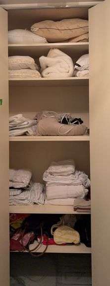 Contents of closet include towels, sheets, pillows, blankets, etc image