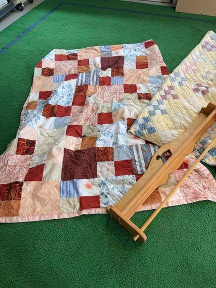 Two quilts and a quilt wall rack image