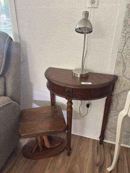 Half round table, small lamp and wood side table image