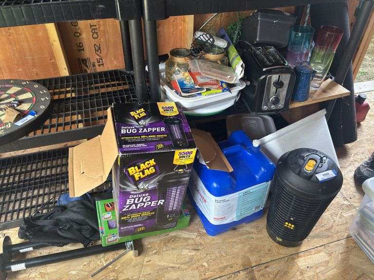 Camping type items - trailer, leveler jacks, water jug, bug zapper image