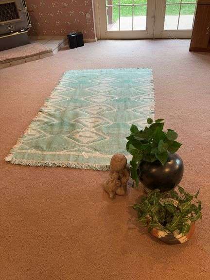 Teal rug, Figurine, pots and floral image