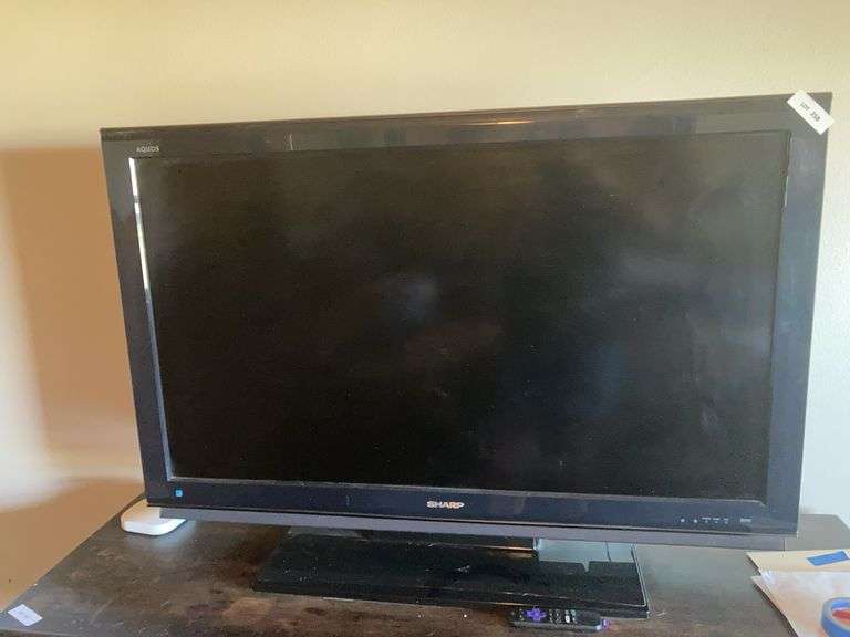 Sharp TV 55” with Roku stick and remote, extra Roku items image
