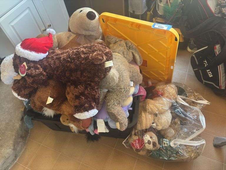 Large assortment of stuffed animals and black, heavy duty storage tote image