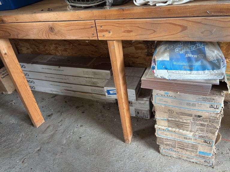 Four boxes of Pergo flooring and assorted tile image