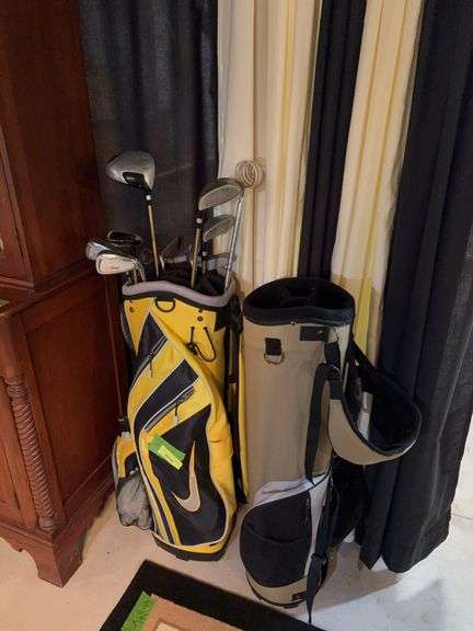 Two golf bags and clubs image