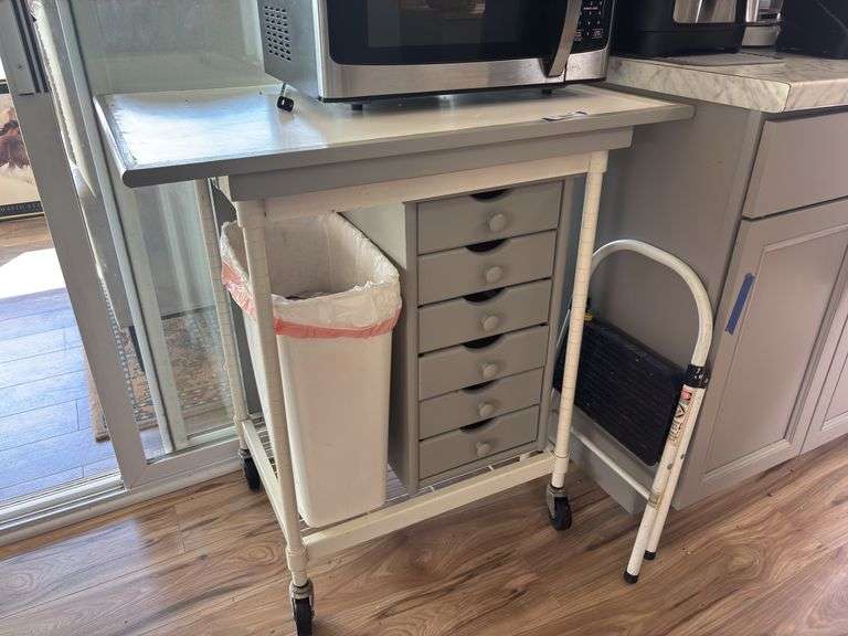 Rolling storage cart with drawers currently used as microwave stand image