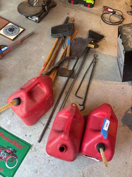 Three gas cans, two hooks, handles, shovels image