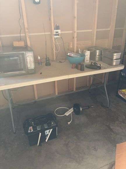 Folding table, stainless containers, Microwave, items on floor image