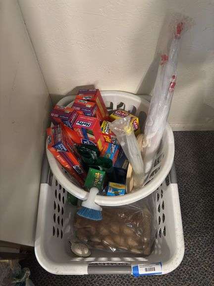 Two laundry baskets with lots of kitchen bags and plasticware plus outdoor food protectors image
