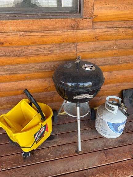 Jack Daniel’s Weber charcoal grill, mop bucket, propane bottle image
