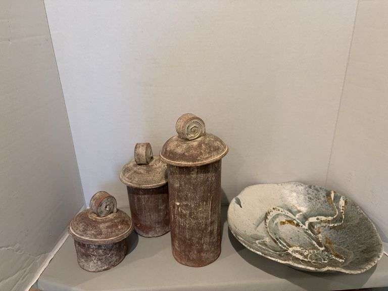 Four pieces decorative pottery, three are like canisters image
