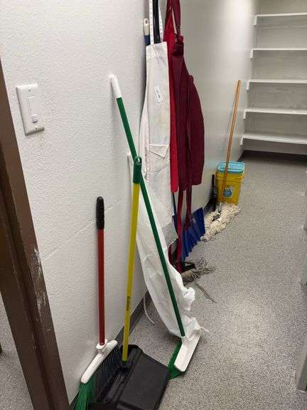 Aprons, brooms, dust pan, mops image
