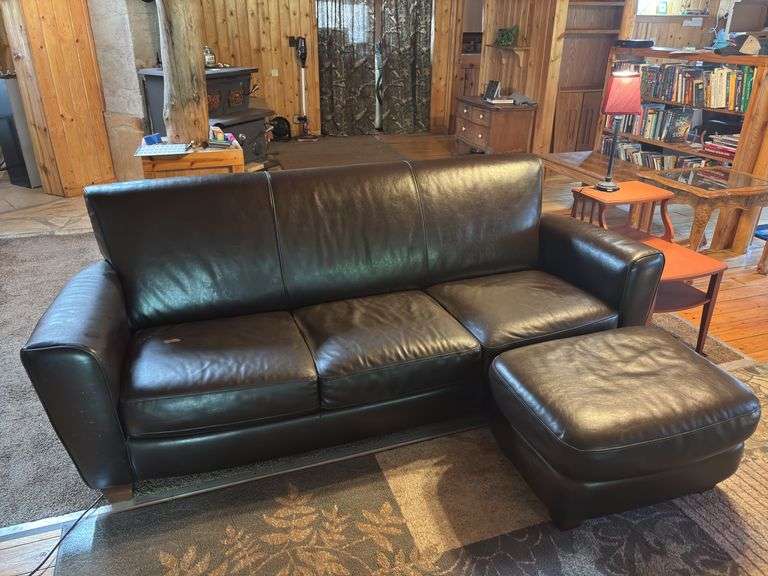 Sofa with ottoman with side table and small lamp - sofa has some wear spots image